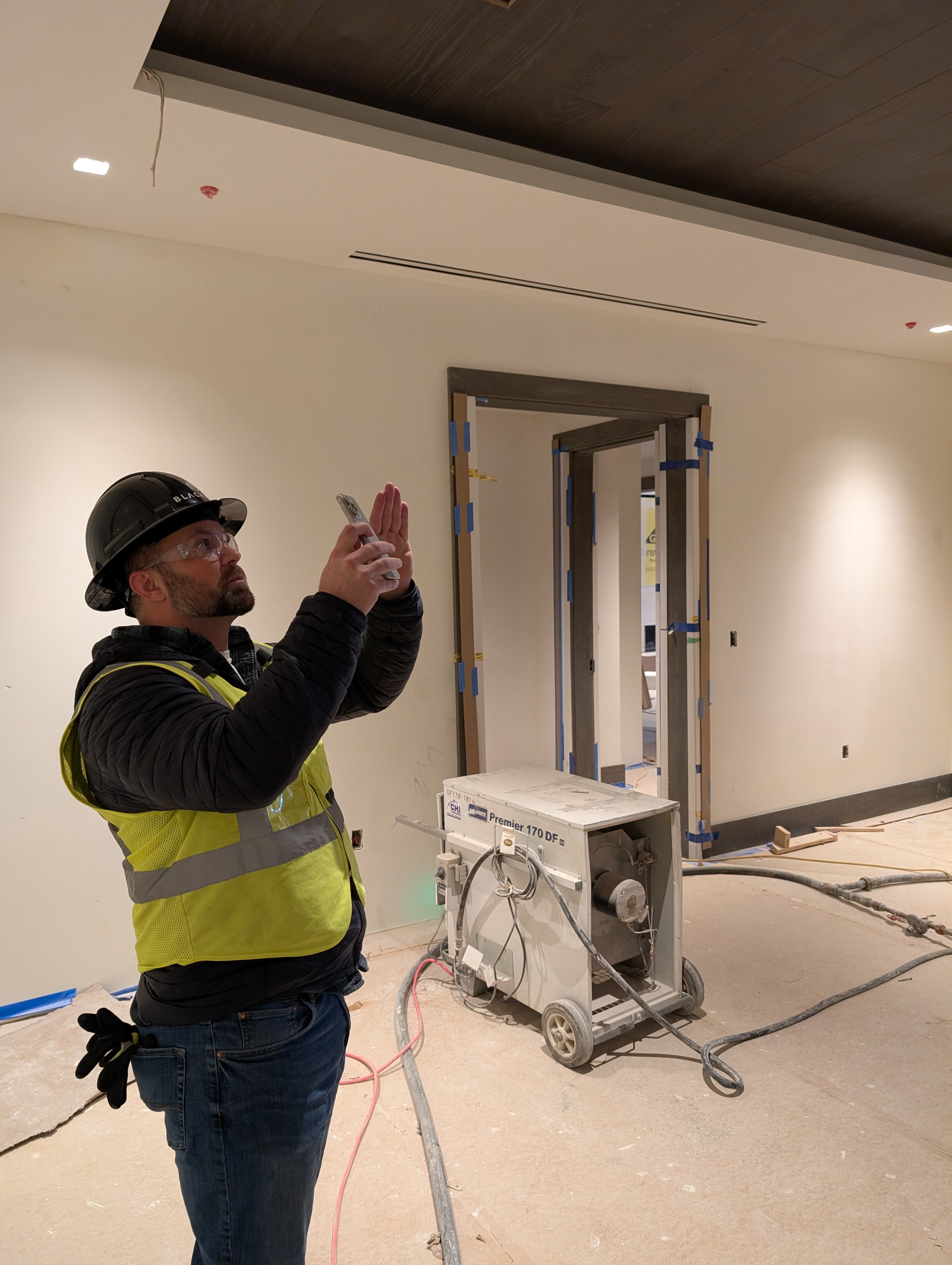 Ryan documenting with phone on jobsite